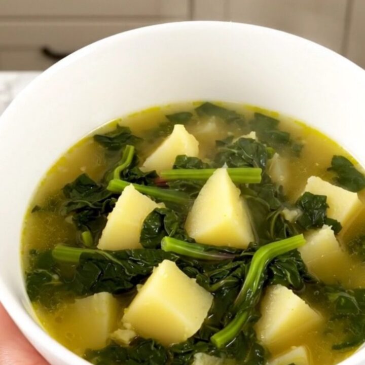A rustic Swiss chard and potato soup in a slow cooker on a quartz countertop.