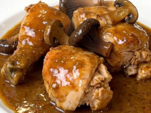 A top-down view of the finished creamy chicken dish with black trumpet mushrooms in a white bowl.