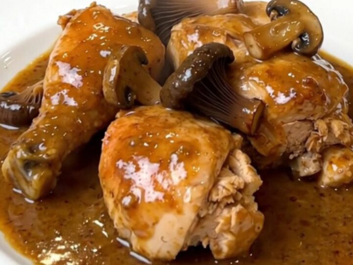 A top-down view of the finished creamy chicken dish with black trumpet mushrooms in a white bowl.
