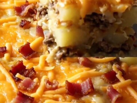 A top-down view of a rectangular baking dish filled with raw ground beef and sliced potatoes, ready for the oven.