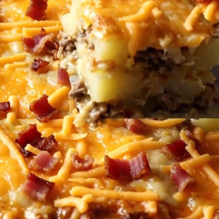 A top-down view of a rectangular baking dish filled with raw ground beef and sliced potatoes, ready for the oven.