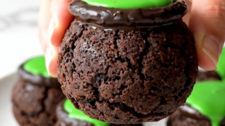 A close-up view of no-bake cookie truffle cauldrons arranged on a white plate.