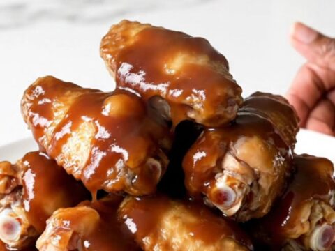 A plate of sticky, glazed chicken wings fresh from the slow cooker.