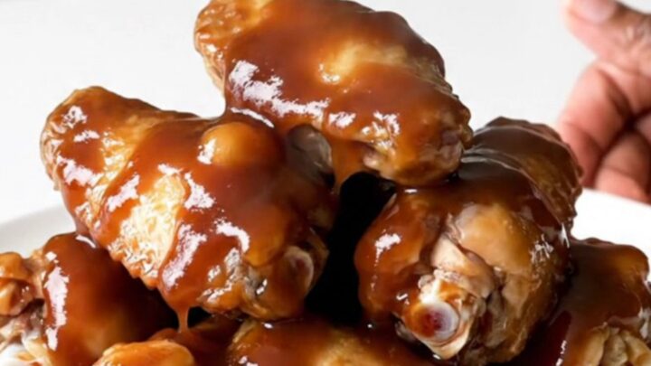 A plate of sticky, glazed chicken wings fresh from the slow cooker.