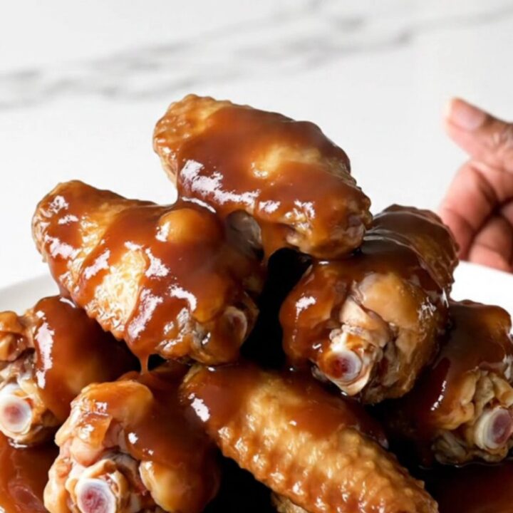 A plate of sticky, glazed chicken wings fresh from the slow cooker.