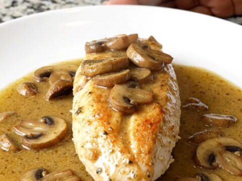 A serving of creamy slow cooker Chicken Marsala with mushrooms on a white plate.