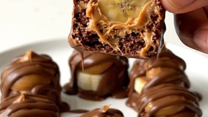 A close-up view of peanut butter chocolate banana bites arranged on a white plate.