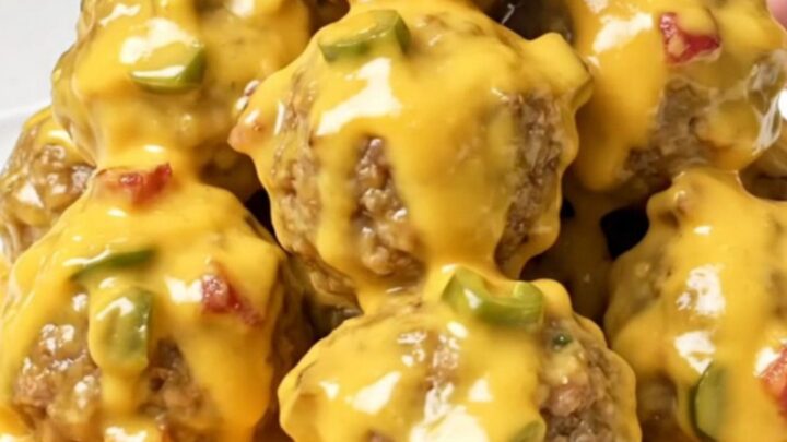 A close-up of tender turkey meatballs generously coated in a thick