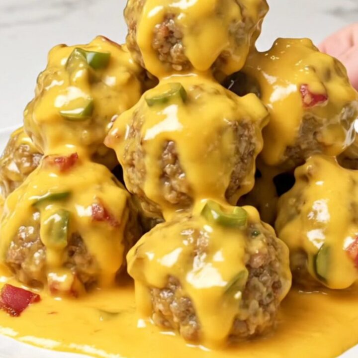 A close-up of tender turkey meatballs generously coated in a thick