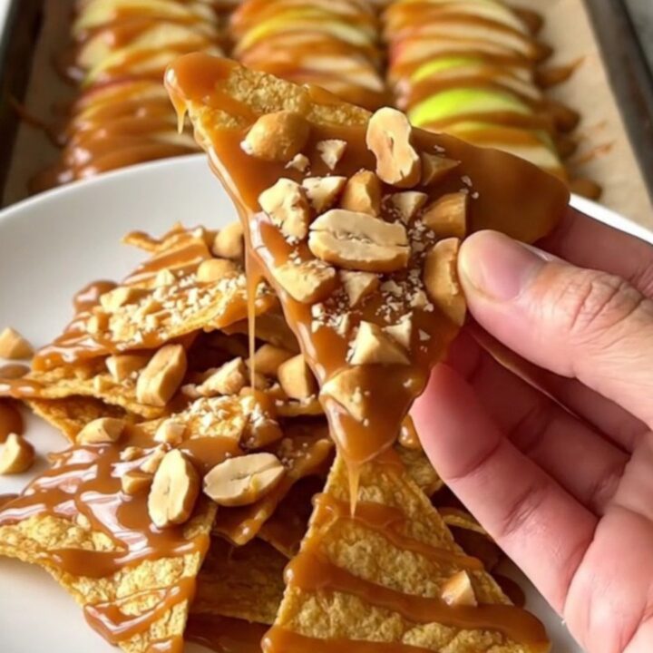 A top-down view of fanned red and green apple slices on a parchment-lined baking sheet