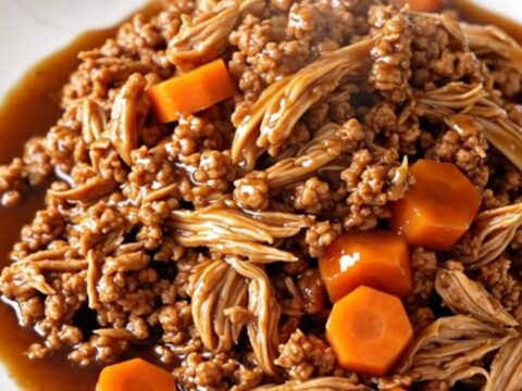 A bowl of savory Korean-style ground turkey with carrots served over white rice.