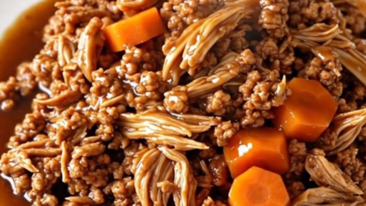 A bowl of savory Korean-style ground turkey with carrots served over white rice.