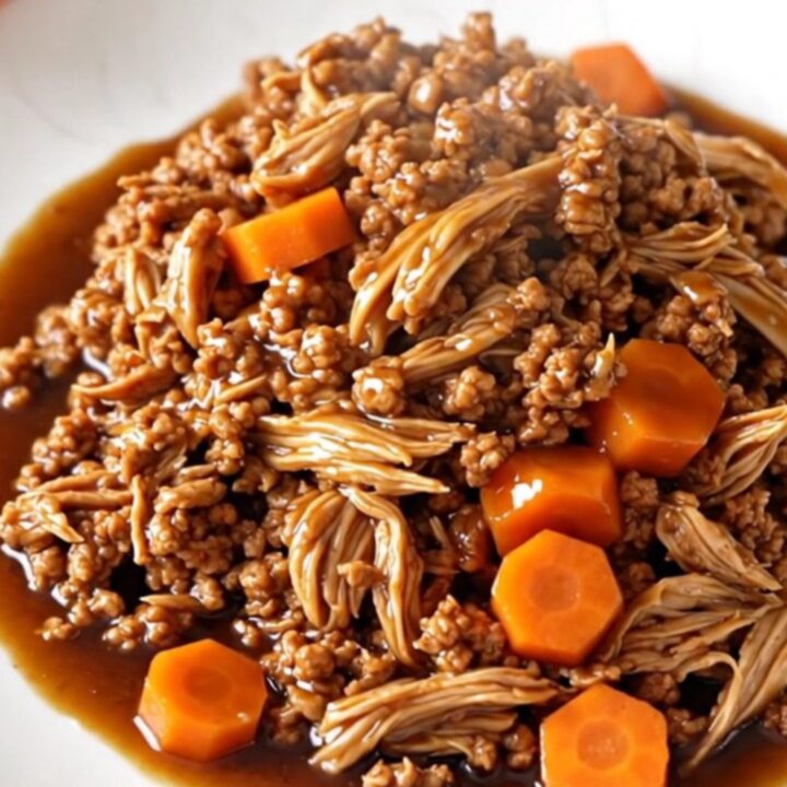A bowl of savory Korean-style ground turkey with carrots served over white rice.