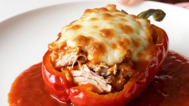 A top-down view of bell peppers stuffed with ground turkey and topped with melted mozzarella in a slow cooker.