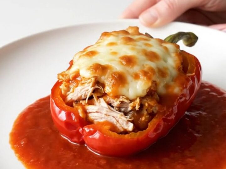 A top-down view of bell peppers stuffed with ground turkey and topped with melted mozzarella in a slow cooker.