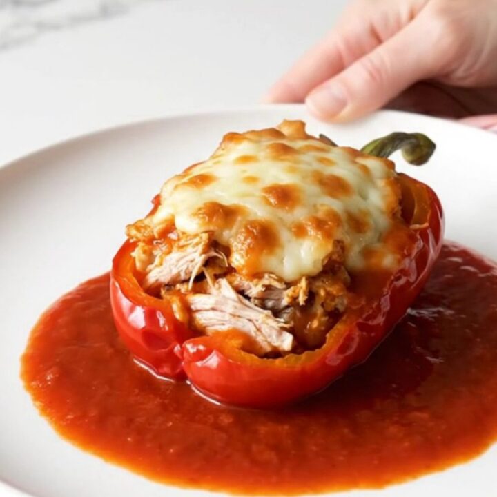 A top-down view of bell peppers stuffed with ground turkey and topped with melted mozzarella in a slow cooker.
