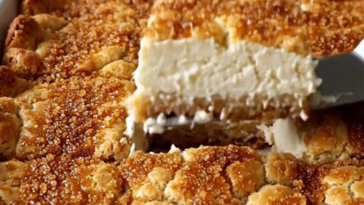 A close-up view of golden brown Sopapilla Cheesecake Bars with a visible creamy layer inside.