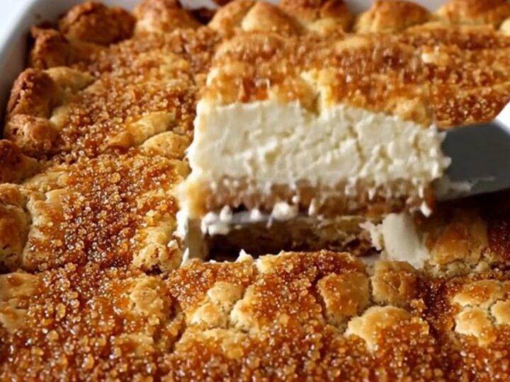 A close-up view of golden brown Sopapilla Cheesecake Bars with a visible creamy layer inside.