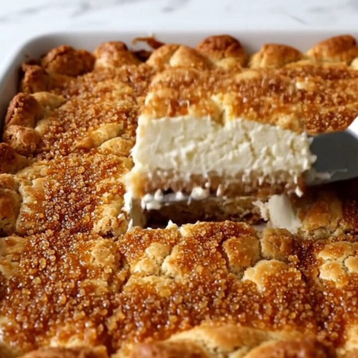A close-up view of golden brown Sopapilla Cheesecake Bars with a visible creamy layer inside.