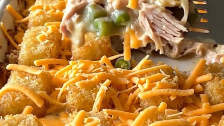 A top-down view of a rectangular baking dish filled with a creamy turkey and green bean base