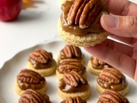A close-up shot of no-bake pecan pie bites arranged on a plate, featuring a vanilla wafer base, a brown sugar pecan filling