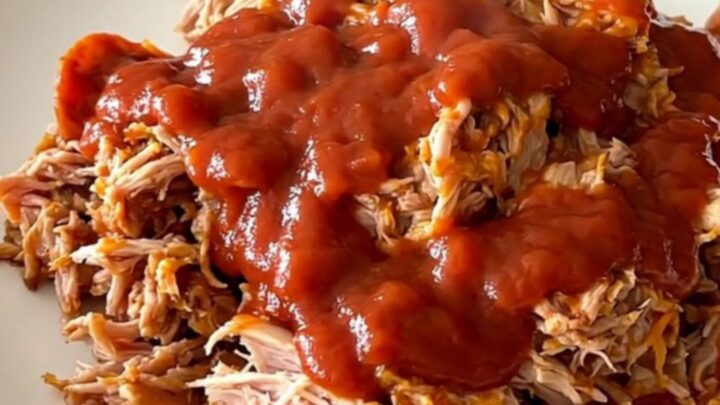 A close-up of a slow cooker filled with ground turkey, pepperoni, and rich red pizza sauce.