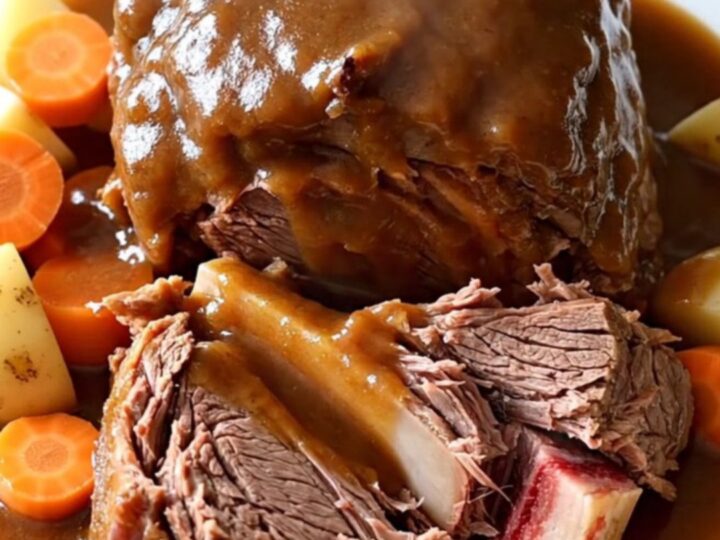 A rustic, slow-cooked Yankee pot roast with chunks of tender beef, carrots, and potatoes in a rich brown gravy.