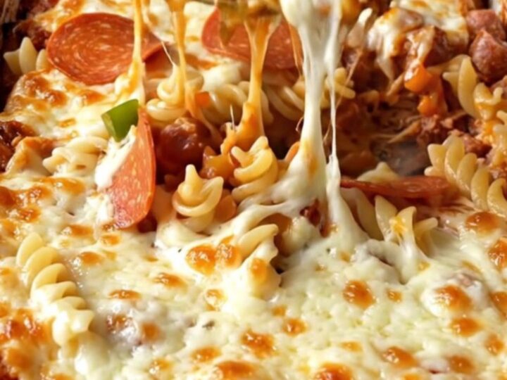 A top-down view of a rectangular baking dish filled with a supreme pizza pasta bake before it enters the oven.