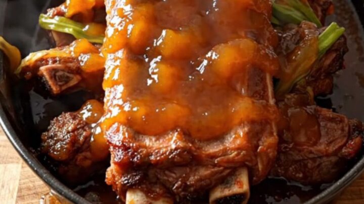 A close-up of tender orange marmalade spareribs in a slow cooker