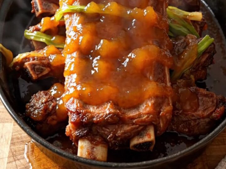 A close-up of tender orange marmalade spareribs in a slow cooker