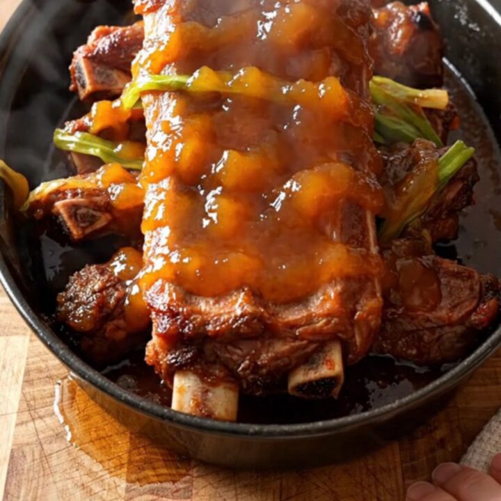 A close-up of tender orange marmalade spareribs in a slow cooker
