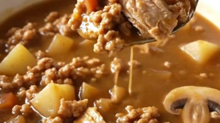 A bowl of ground turkey Salisbury steak soup with mushrooms and potatoes.