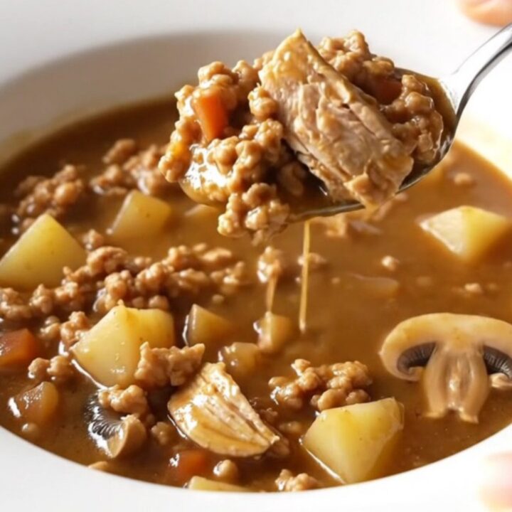 A bowl of ground turkey Salisbury steak soup with mushrooms and potatoes.