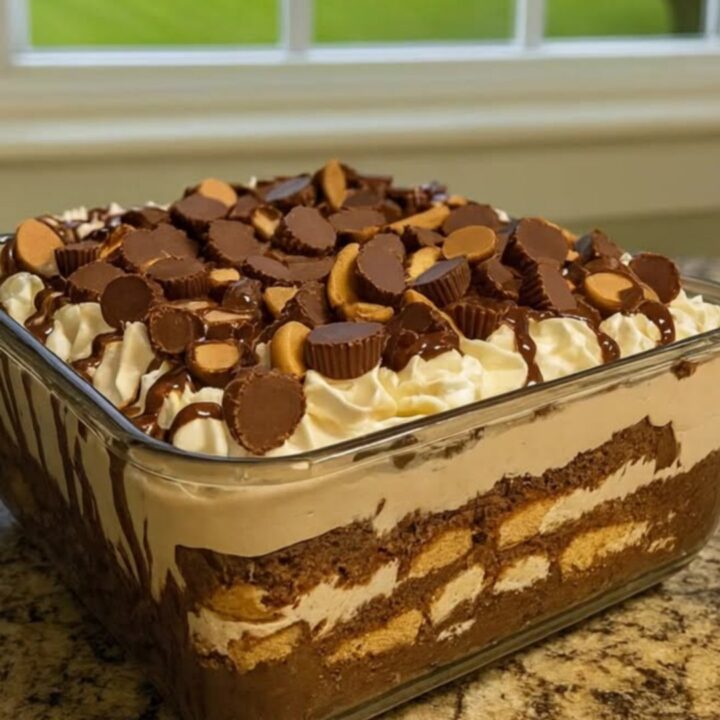 A beautiful peanut butter chocolate trifle in a glass bowl with visible layers.