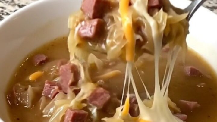 A rustic bowl of creamy Reuben soup filled with corned beef and sauerkraut.