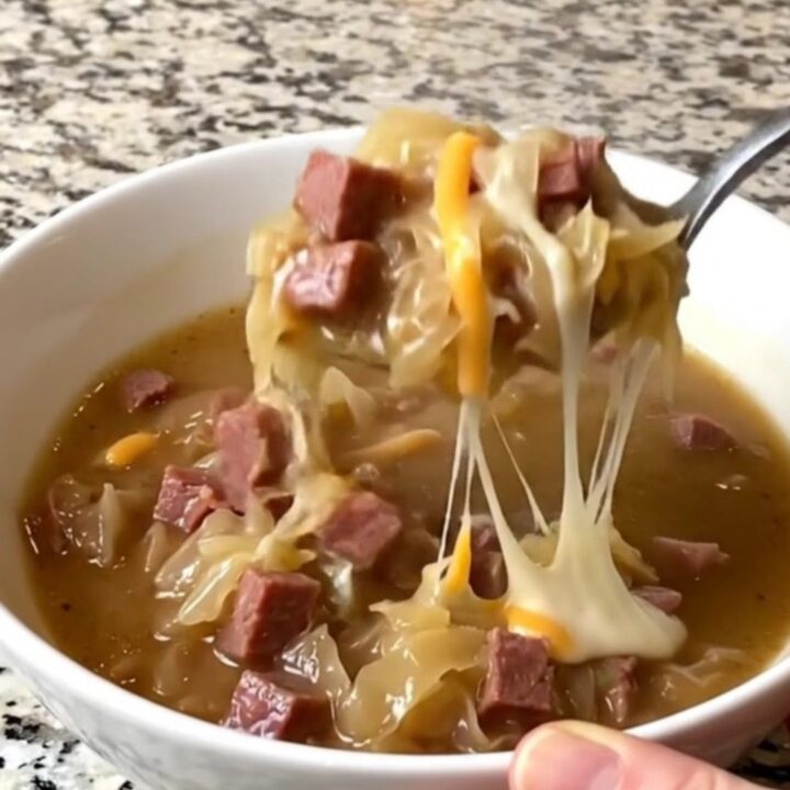 A rustic bowl of creamy Reuben soup filled with corned beef and sauerkraut.