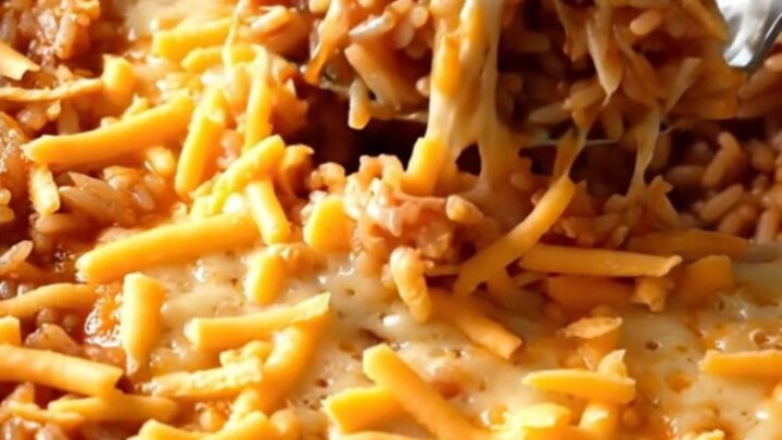 A rectangular baker filled with ground turkey and rice before being baked in the oven.