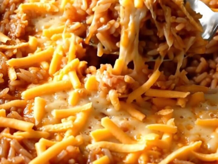 A rectangular baker filled with ground turkey and rice before being baked in the oven.