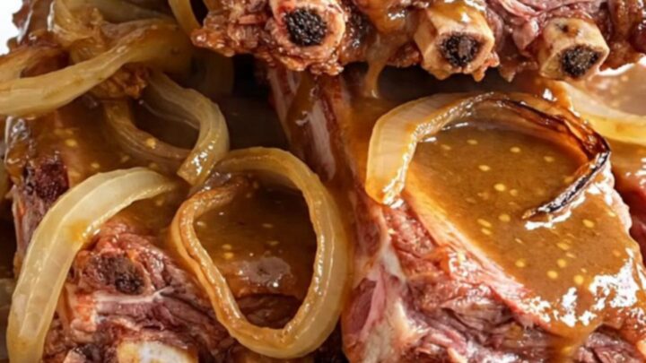 Slow cooker brown sugar Dijon baby back ribs served on a white plate with a glossy sauce.