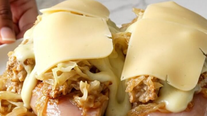 Slow cooker chicken breasts topped with sauerkraut, Thousand Island dressing, and melted Swiss cheese.