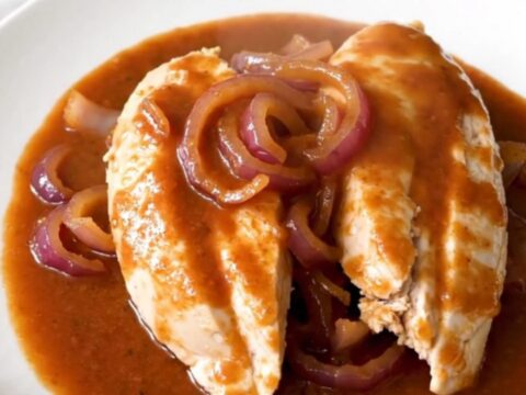 A slow cooker filled with tender chicken breasts glazed in a rich brown sugar and Italian dressing sauce.