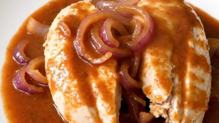 A slow cooker filled with tender chicken breasts glazed in a rich brown sugar and Italian dressing sauce.