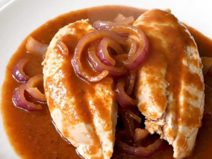 A slow cooker filled with tender chicken breasts glazed in a rich brown sugar and Italian dressing sauce.