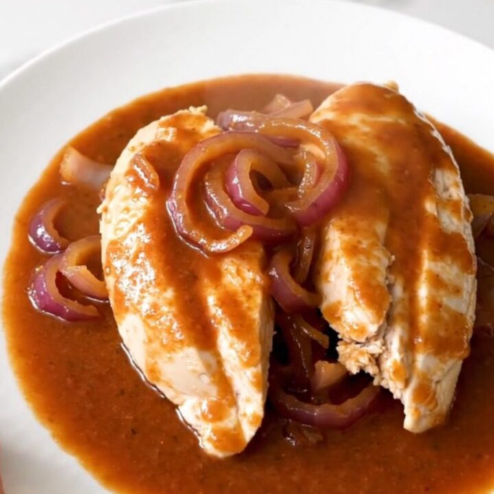 A slow cooker filled with tender chicken breasts glazed in a rich brown sugar and Italian dressing sauce.