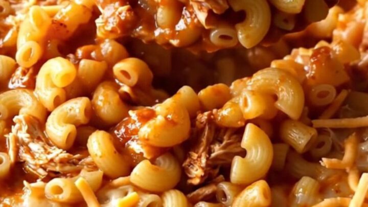 A top-down view of a rectangular baking dish filled with a golden, bubbling ground turkey and macaroni bake.