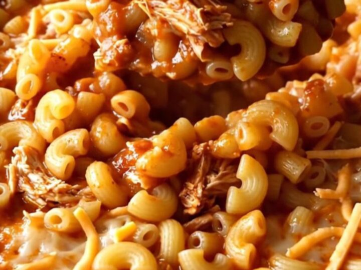 A top-down view of a rectangular baking dish filled with a golden, bubbling ground turkey and macaroni bake.
