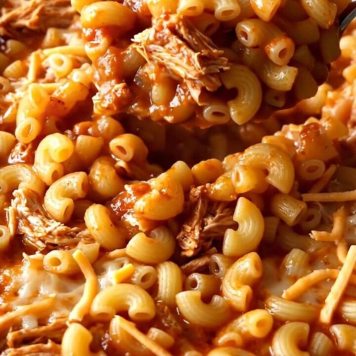 A top-down view of a rectangular baking dish filled with a golden, bubbling ground turkey and macaroni bake.