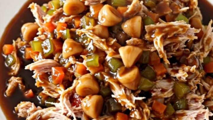 Slow cooker hoisin turkey filling served in crisp green lettuce leaves on a white plate.