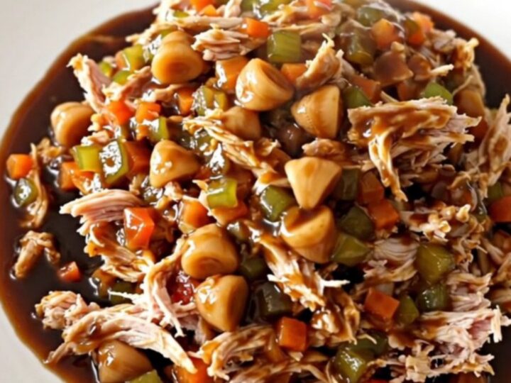 Slow cooker hoisin turkey filling served in crisp green lettuce leaves on a white plate.