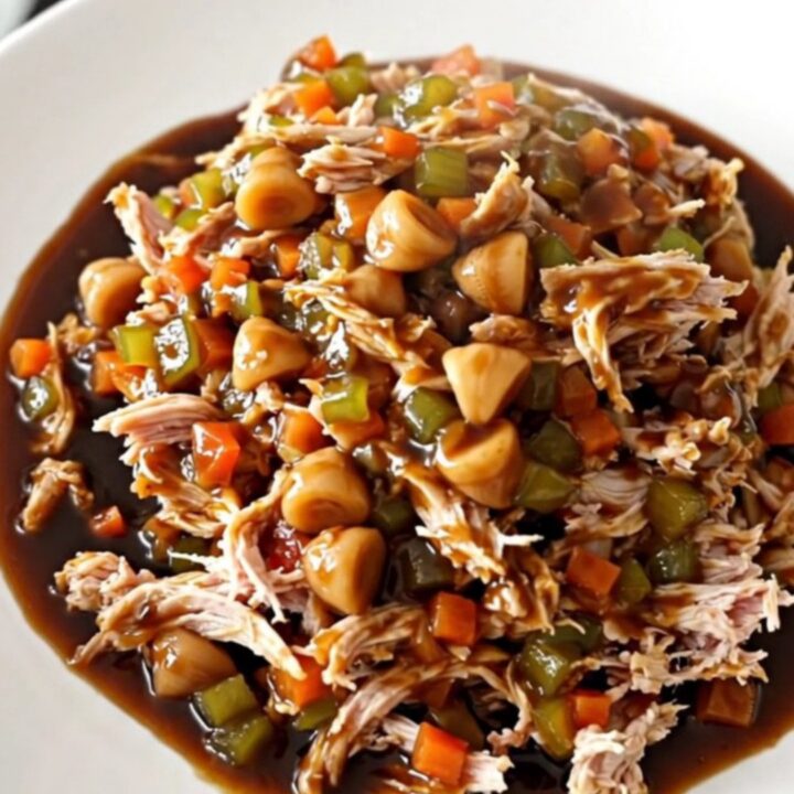 Slow cooker hoisin turkey filling served in crisp green lettuce leaves on a white plate.